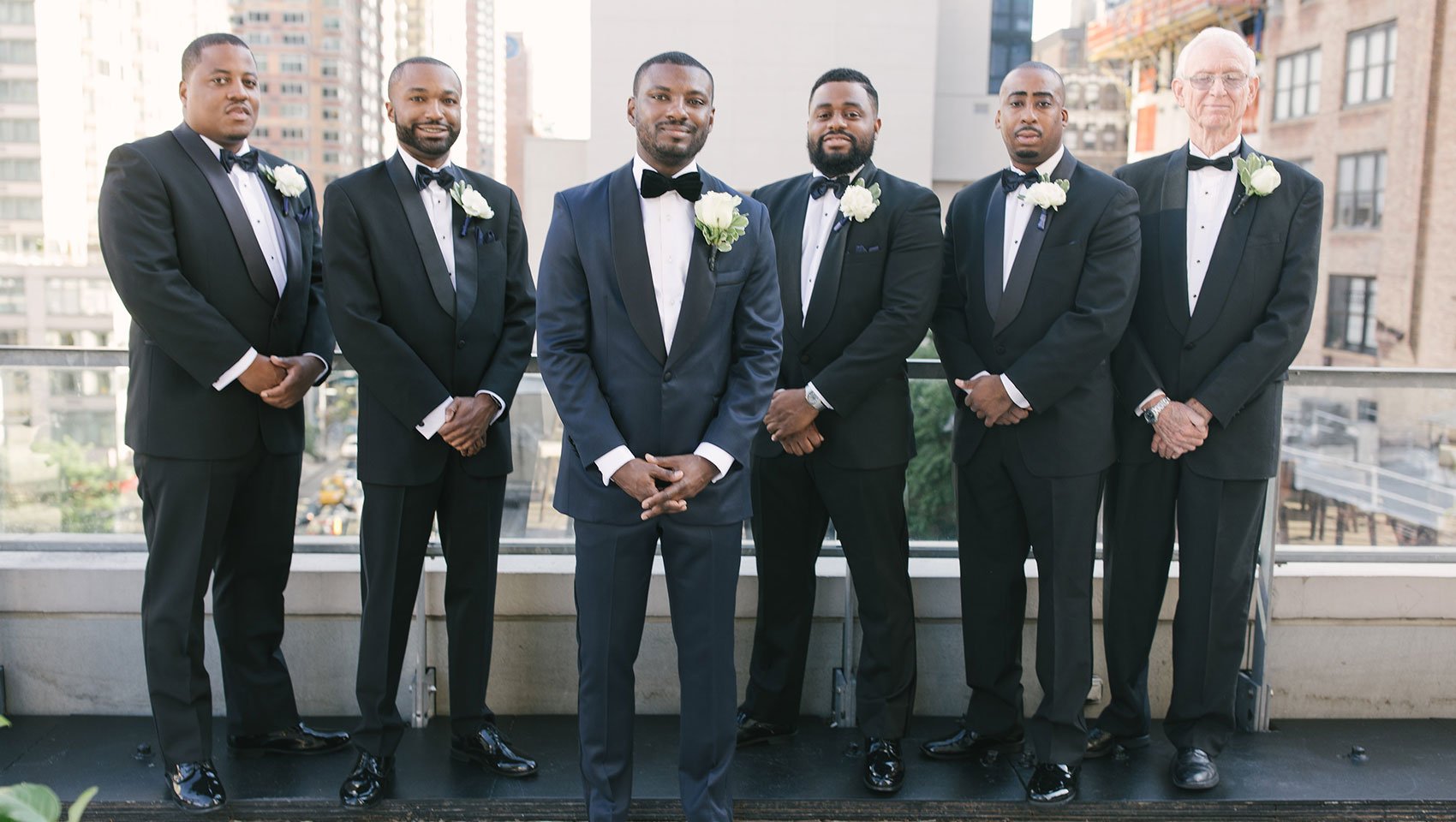 weddingsDaniel with his groomsmen in tuxedos on a balcony