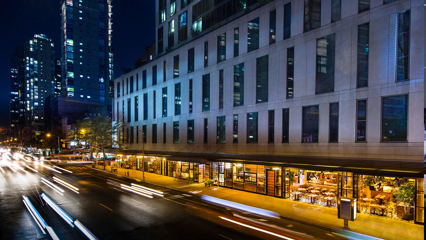 Kimpton Hotel Eventi building exterior with front entrance façade in front of street cars