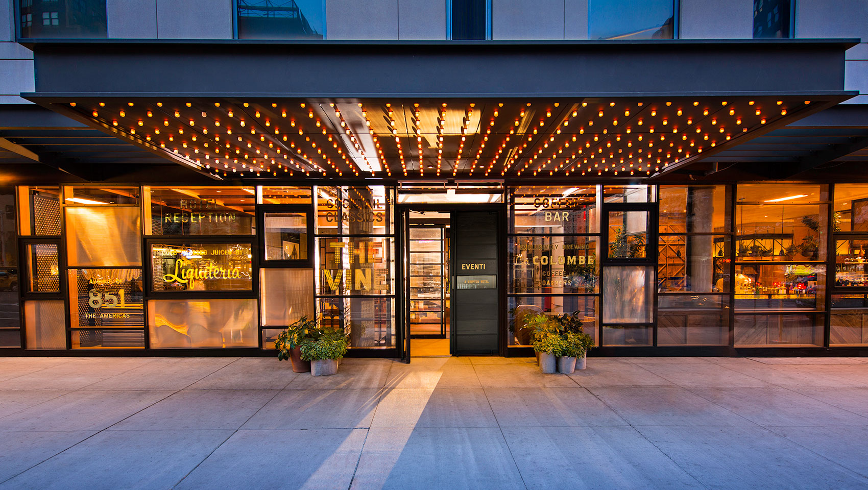 Kimpton Hotel Eventi front entrance façade with lighting and glass walls