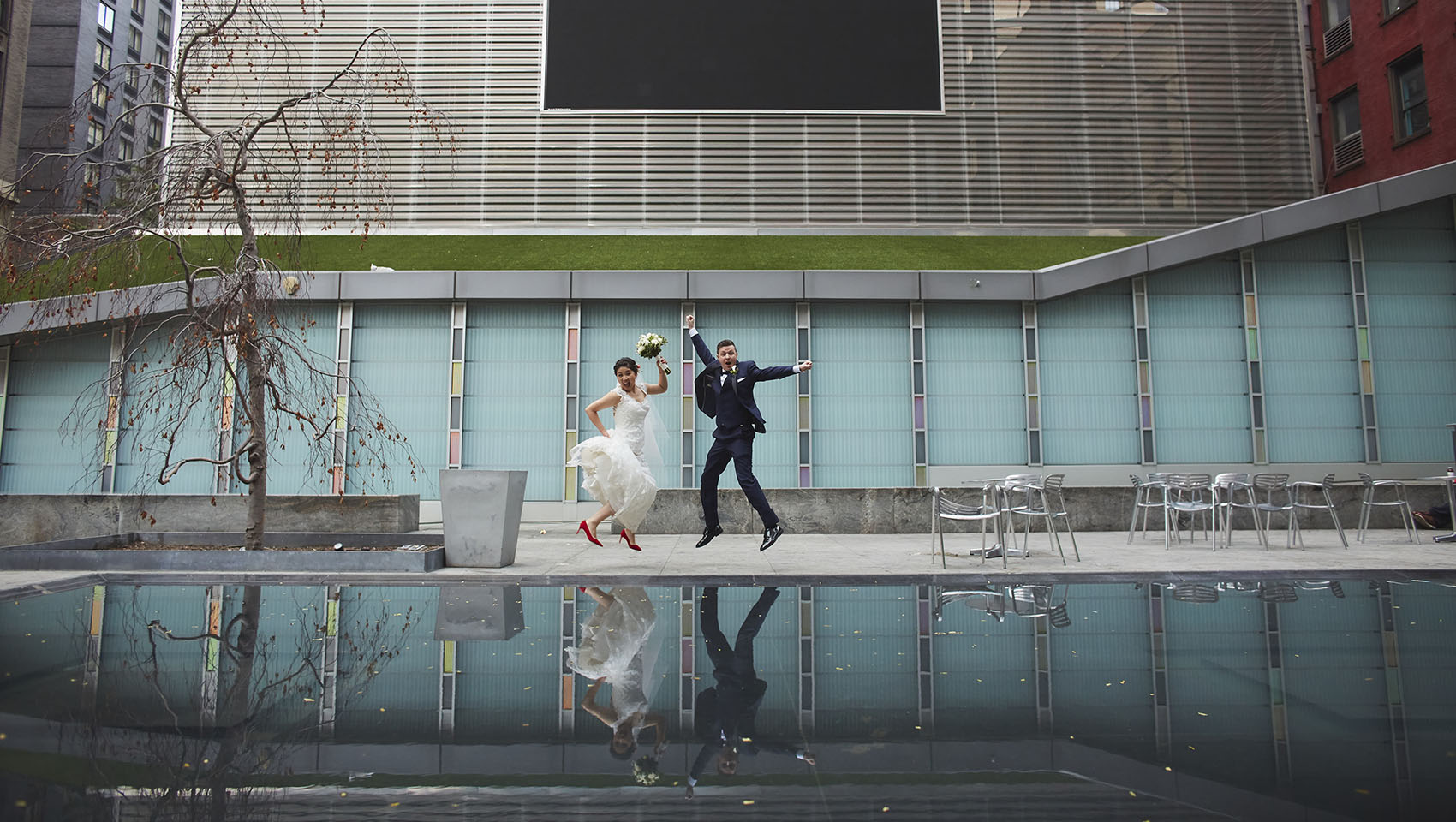 Yoko and Roman jumping in joy at Kimpton Hotel Eventi's Big Screen Plaza
