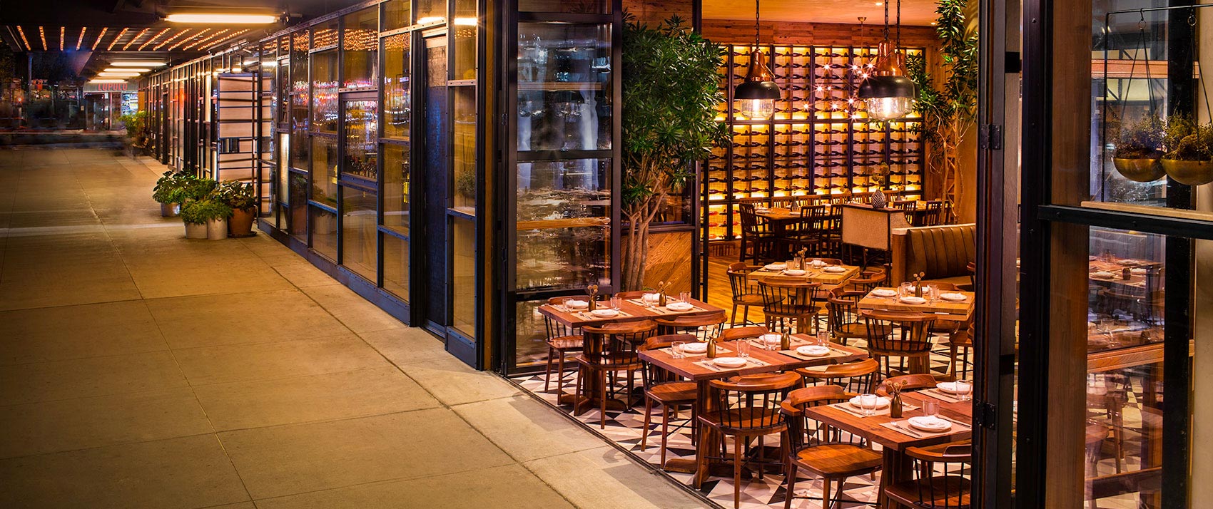 L'Amico restaurant open design with open doors and outdoor seating on sixth avenue
