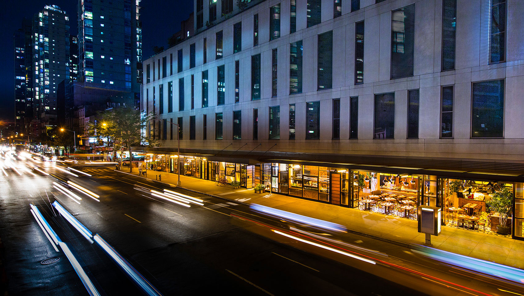 Kimpton Hotel Eventi building exterior with front entrance façade in front of street cars