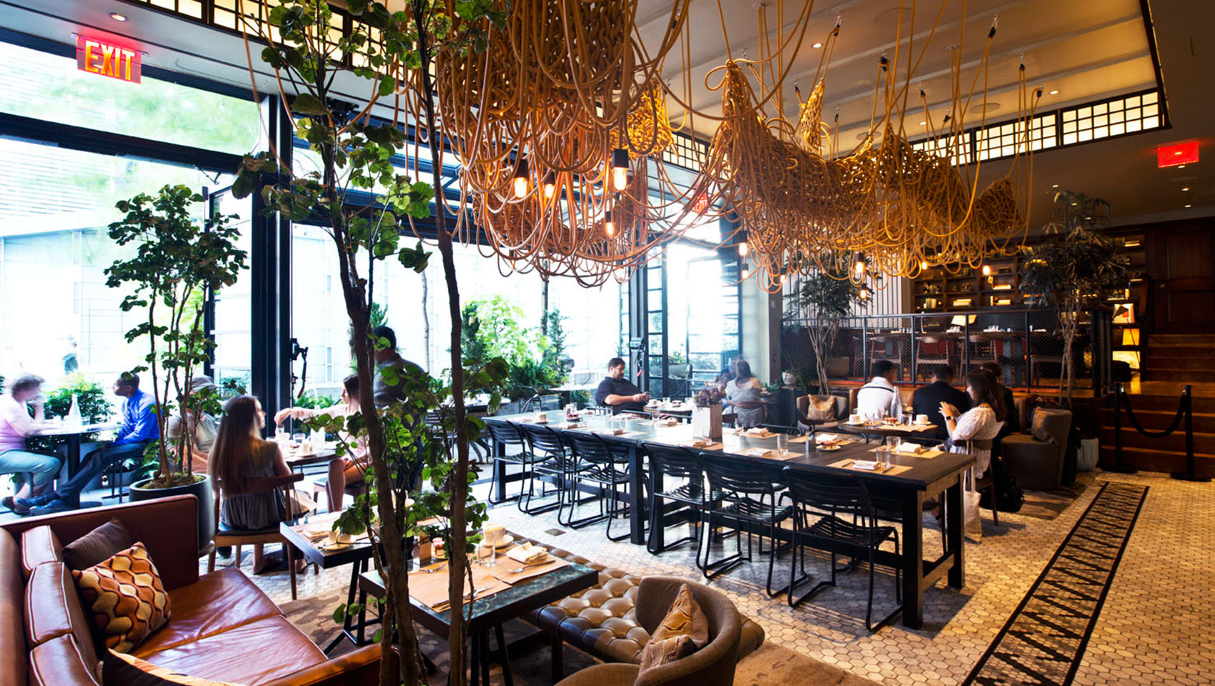 Back Bar restaurant seating under knotted art piece fixture with guests at tables