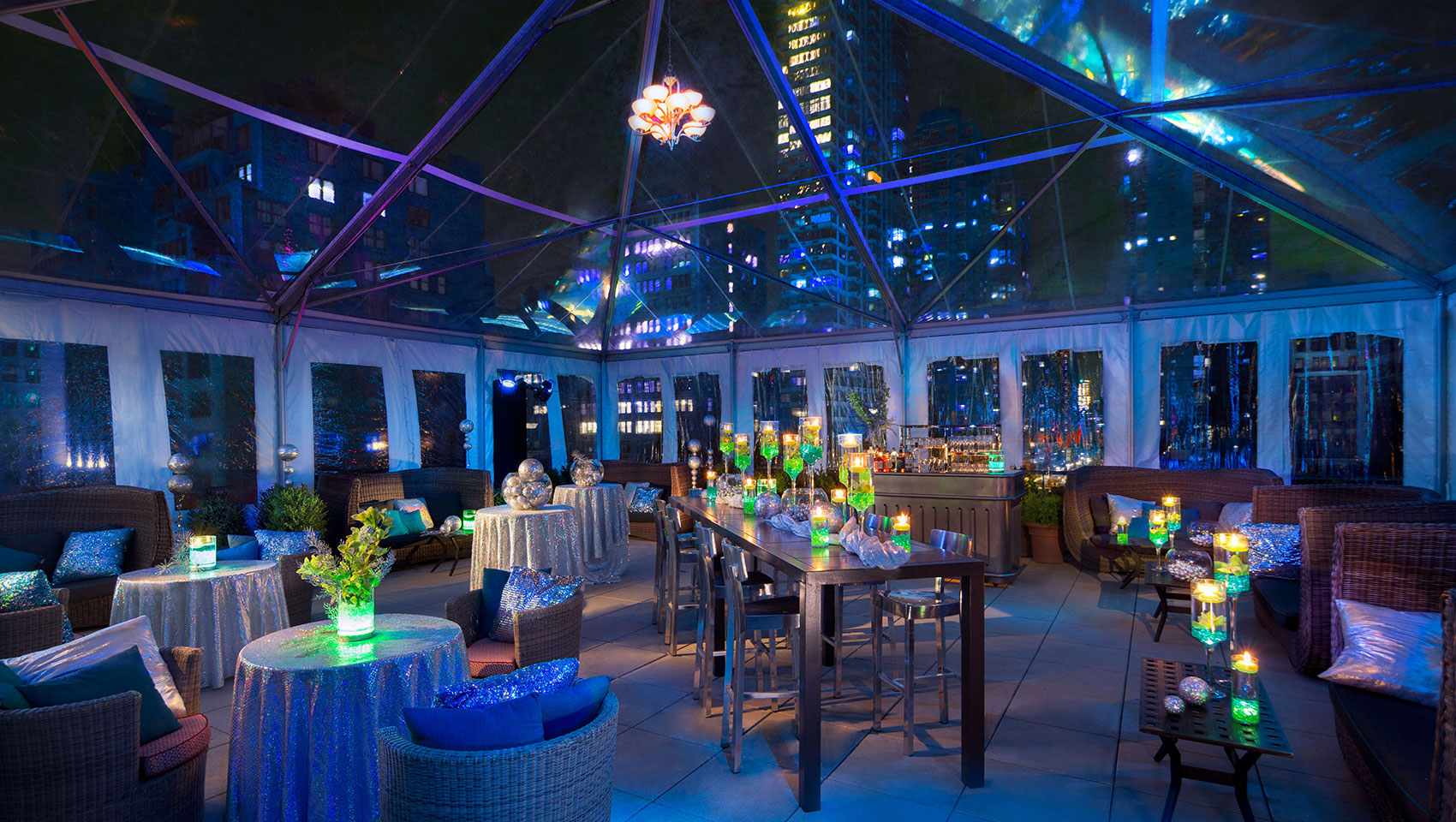 Veranda South tented wedding reception with tables underneath tent with visible views of surrounding skyscrapers