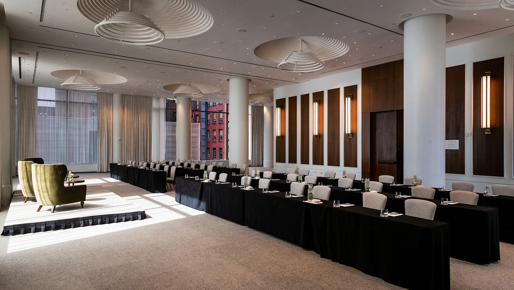 Ventana Ballroom with classroom setup underneath circular fixtures with presenter at front podium