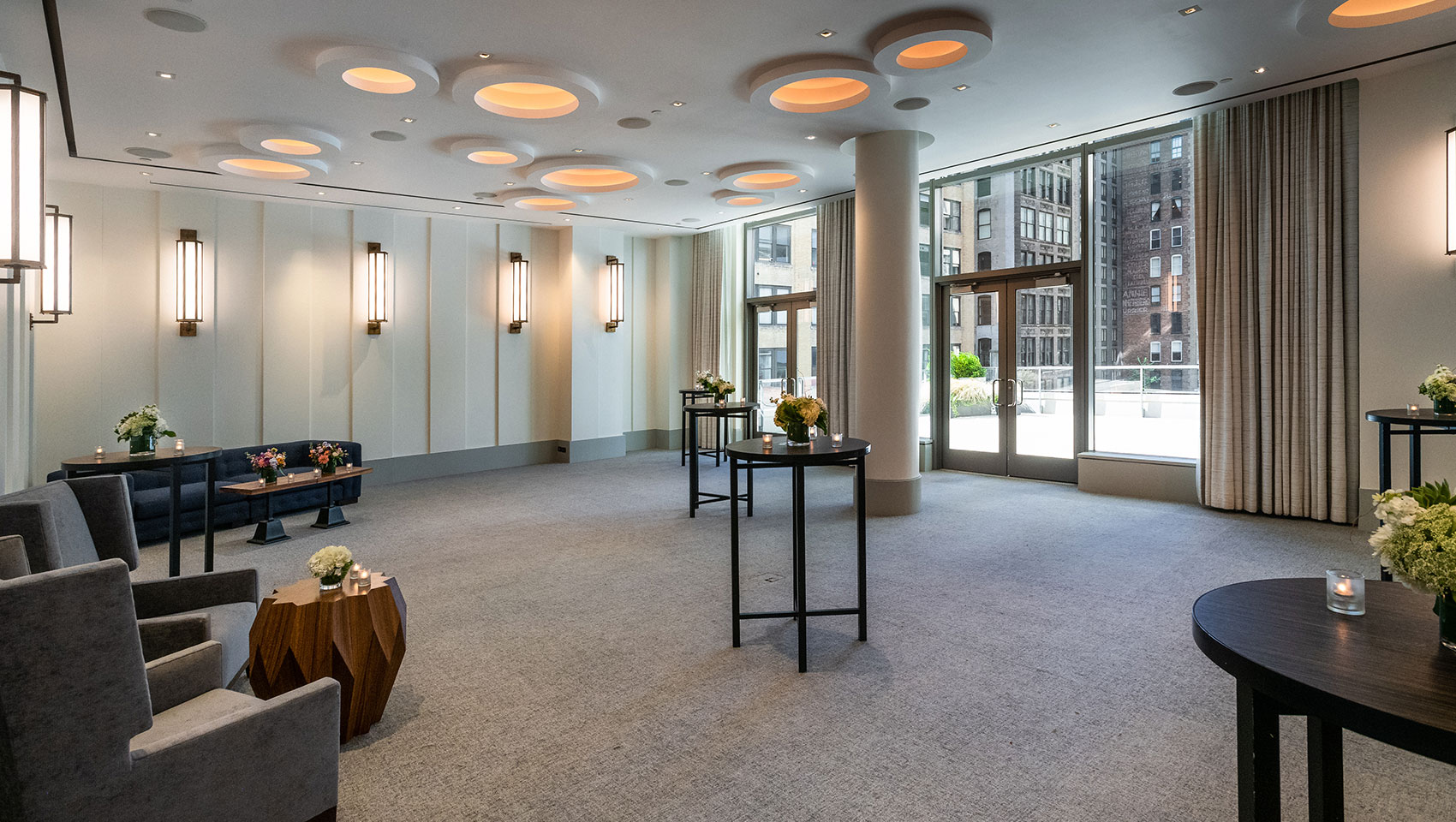 Verdi I, II, and Terrace area set up for wedding reception with circular tables and open balcony area overlooking city views