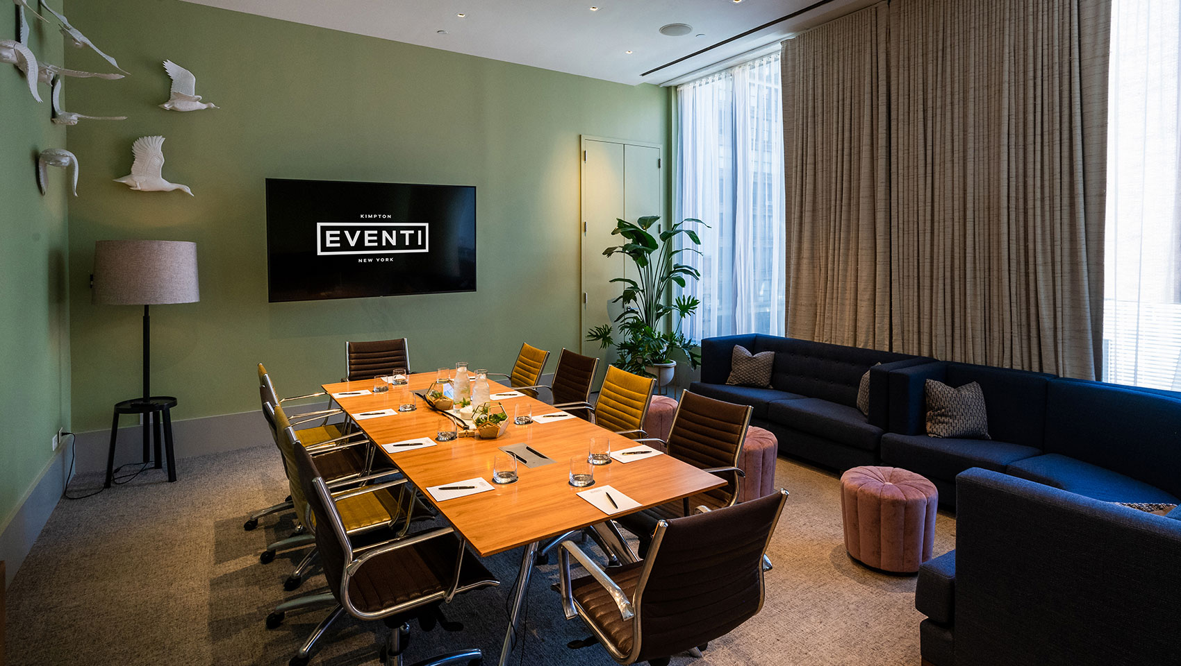 Invent I meeting space with meeting table set with glasses and notepads in sunlit room