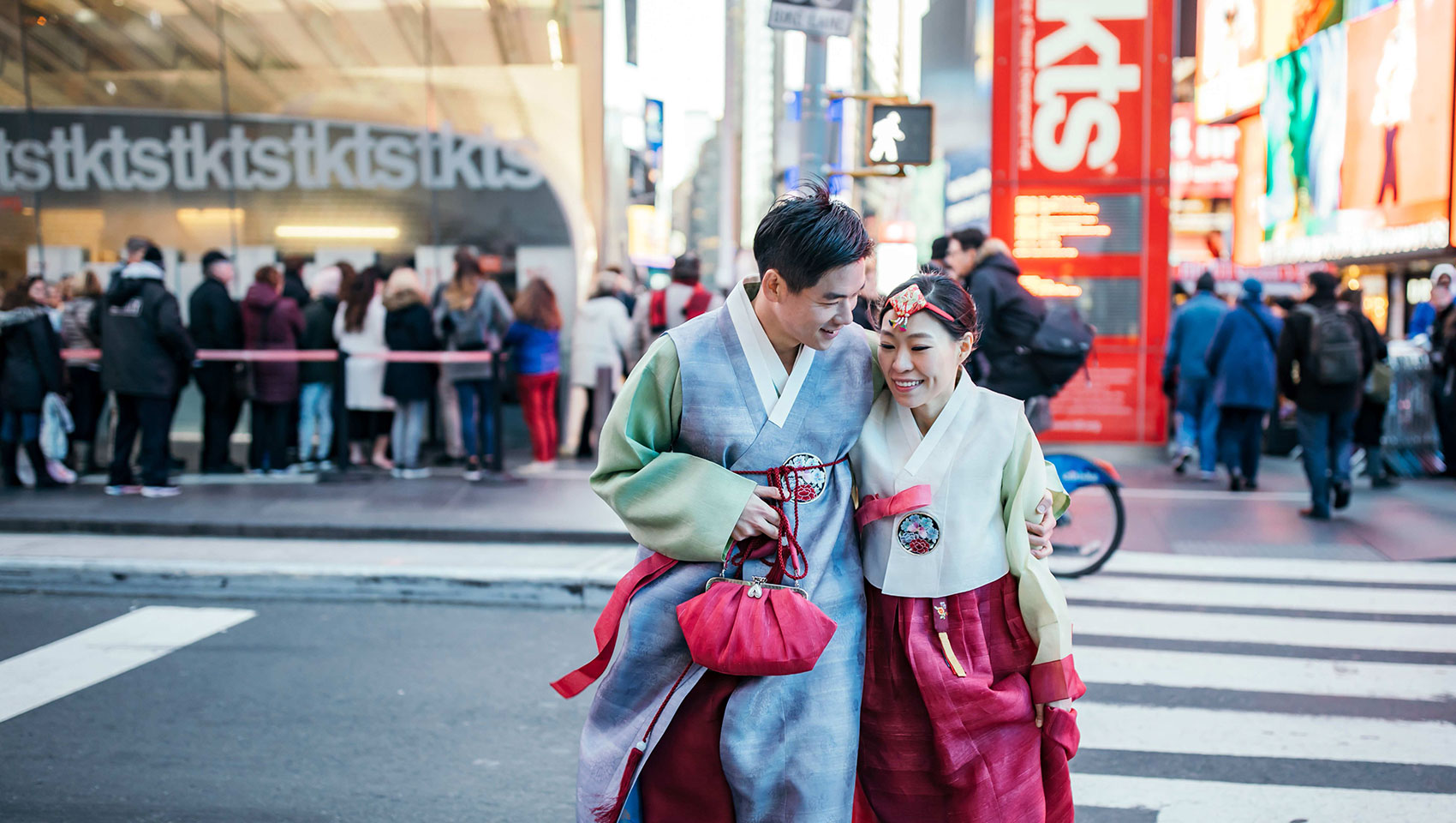 weddingsMunji and Eun Joon holding each other as they cross the street in Times Square