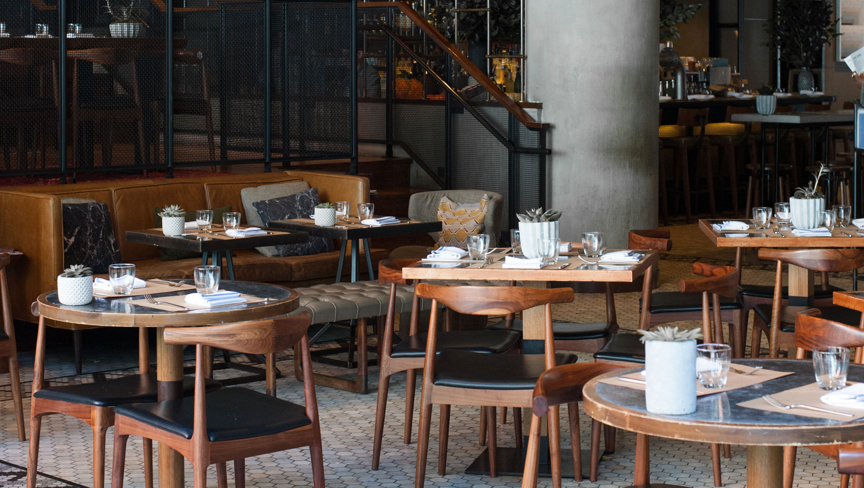 Back Bar tabletop seating with place settings and plants on top of tables