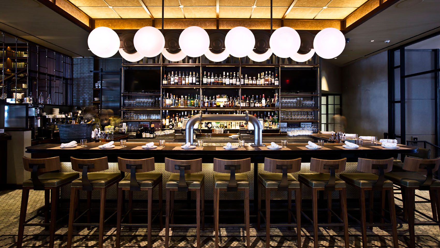 Back Bar seating underneath circular light fixture