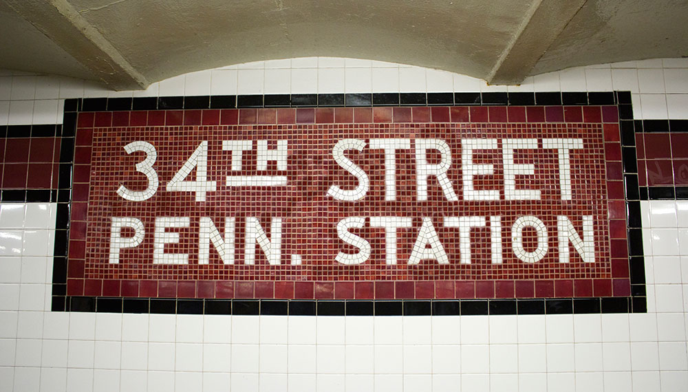 Tiled wall with tiles that spell out "34th STREET PENN. STATION"