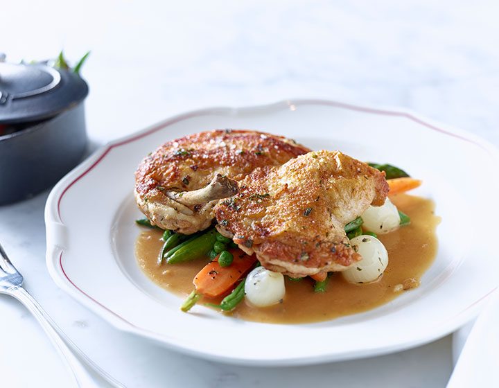 Plated meal with chicken, gravy, and vegetables