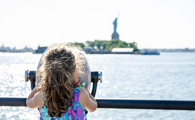 Kid looking at Statue of Liberty