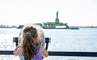 Kid looking at Statue of Liberty