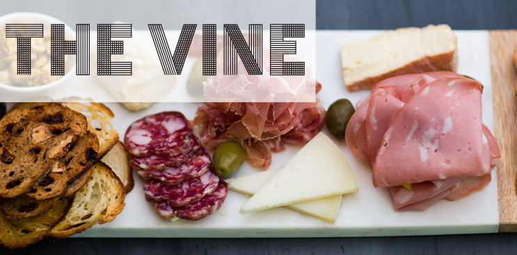Cheeseboard of small bites with toast, meats, and cheeses